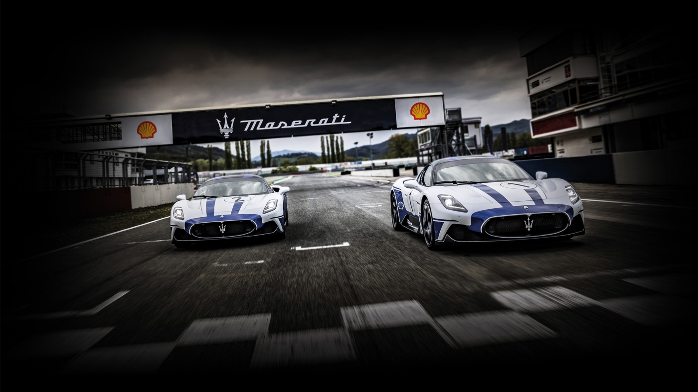 2 Maserati racing cars on racetrack at start grid 